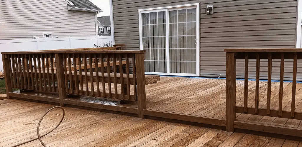 Deck sealing service protecting a backyard wood deck and railings in Kansas City, MO