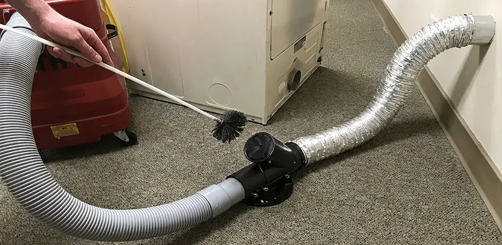 Dryer vent cleaning service removing lint from a dryer duct connection in Kansas City, MO