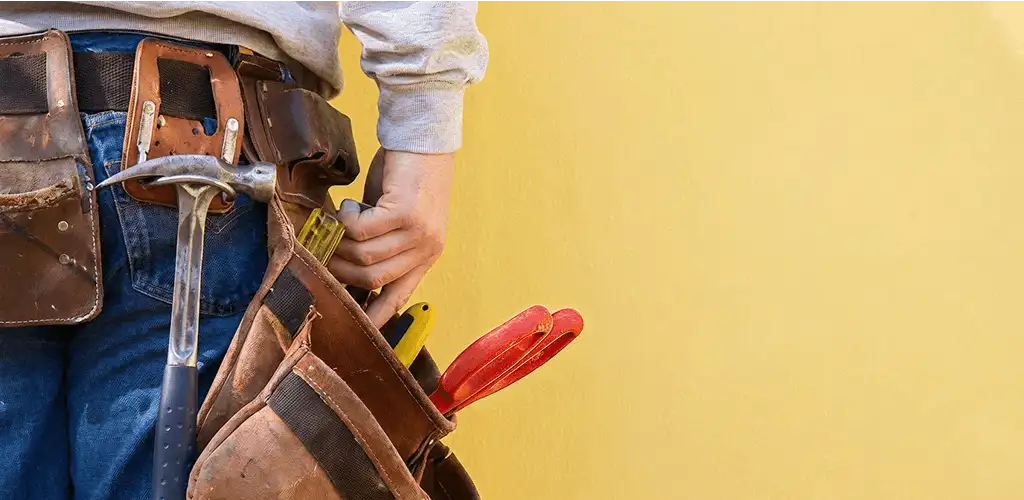 Handyman with tool belt ready for home repairs and maintenance in Kansas City, MO