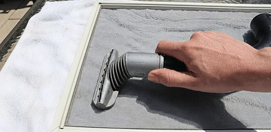 Window screen repair cleaning and fixing a damaged screen mesh in Kansas City, MO