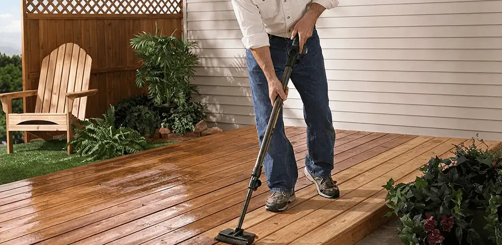 Deck staining service applying stain to a backyard wood deck in Kansas City, MO